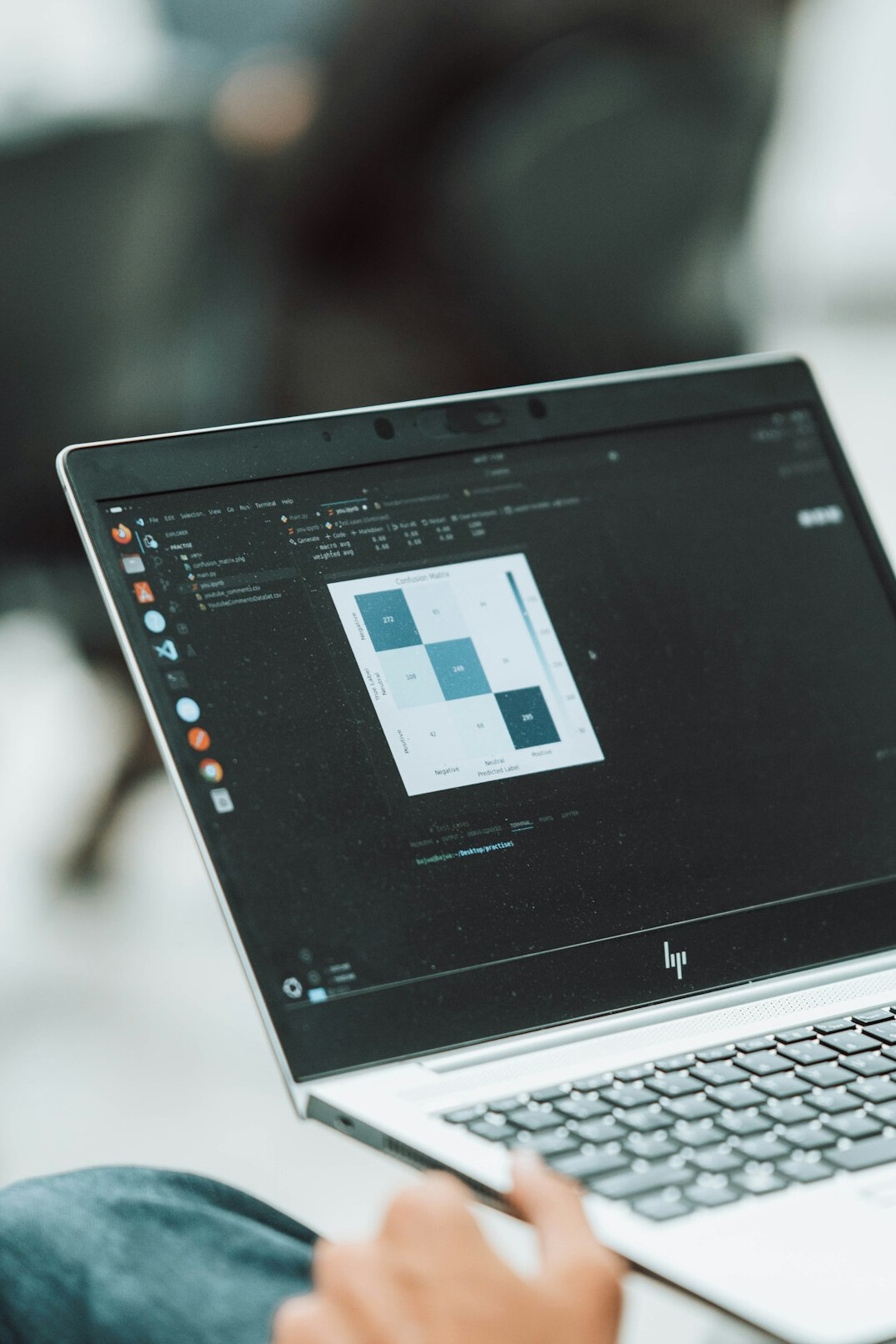 person coding on laptop at home