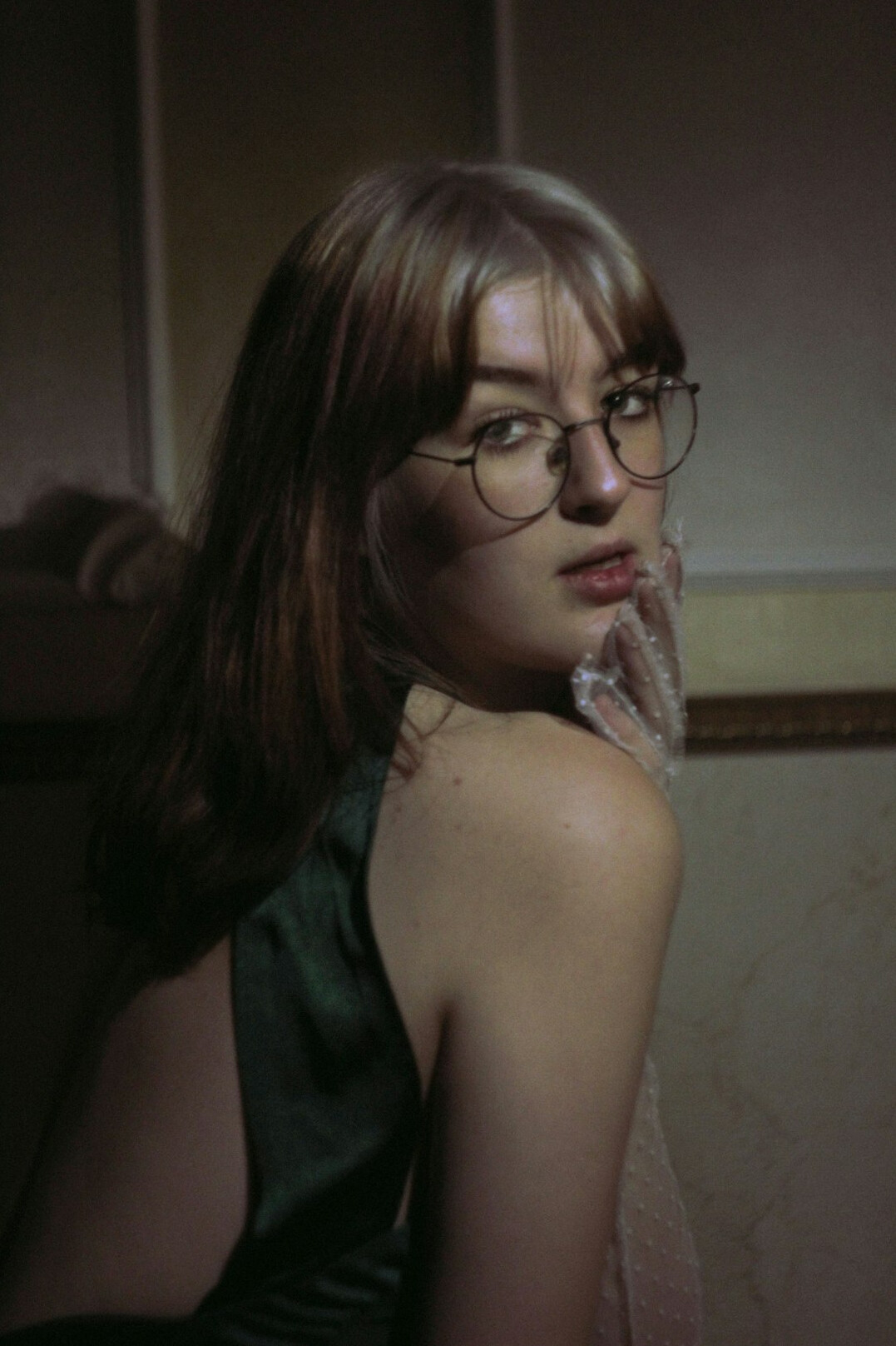 Studio portrait of a young woman with glasses