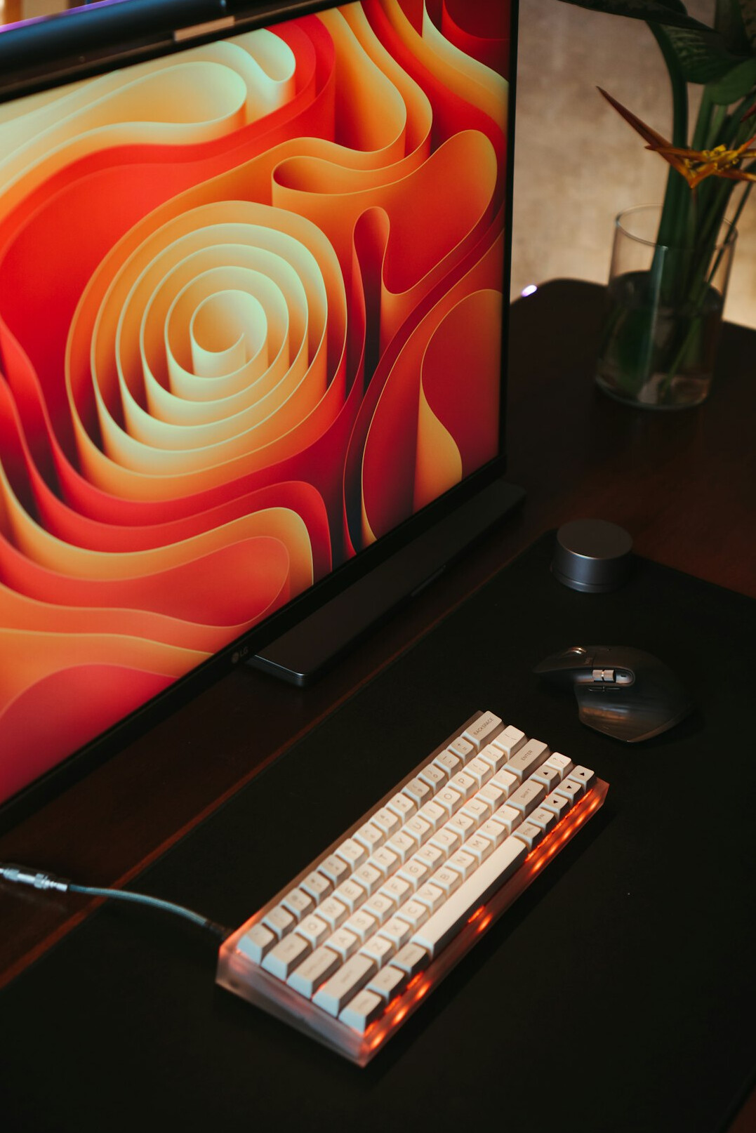 Desk setup with keyboard and monitor showing code